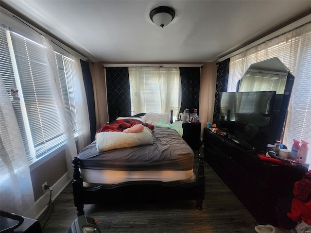 bedroom with dark wood-type flooring