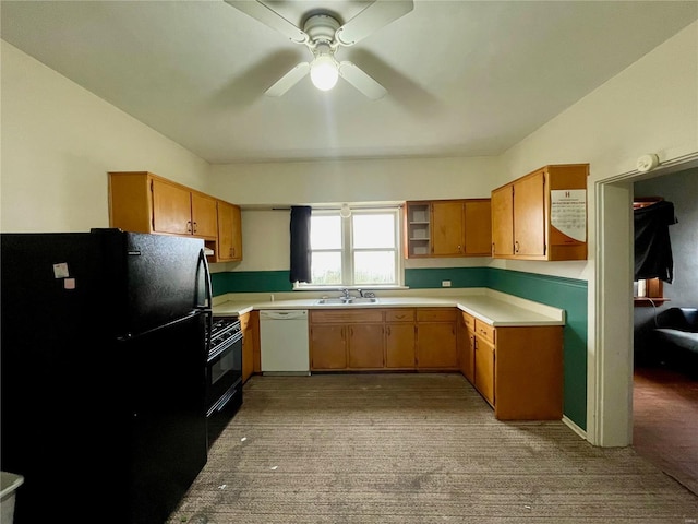 kitchen with black appliances, ceiling fan, light colored carpet, and sink