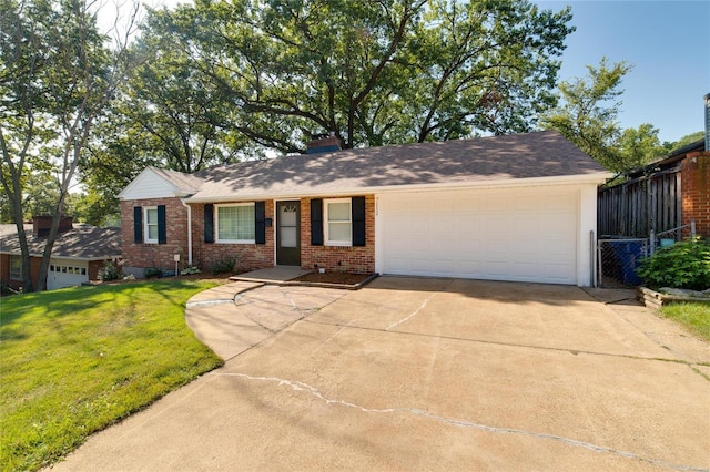 ranch-style house featuring a front lawn and a garage