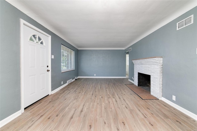 unfurnished living room featuring a fireplace and light hardwood / wood-style flooring