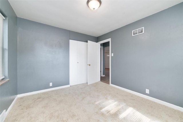 unfurnished bedroom with carpet and a closet