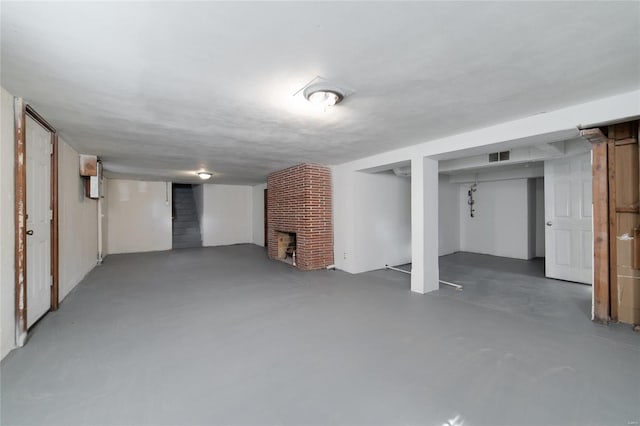 basement featuring a brick fireplace