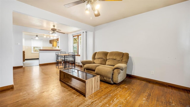 living room with hardwood / wood-style floors and ceiling fan