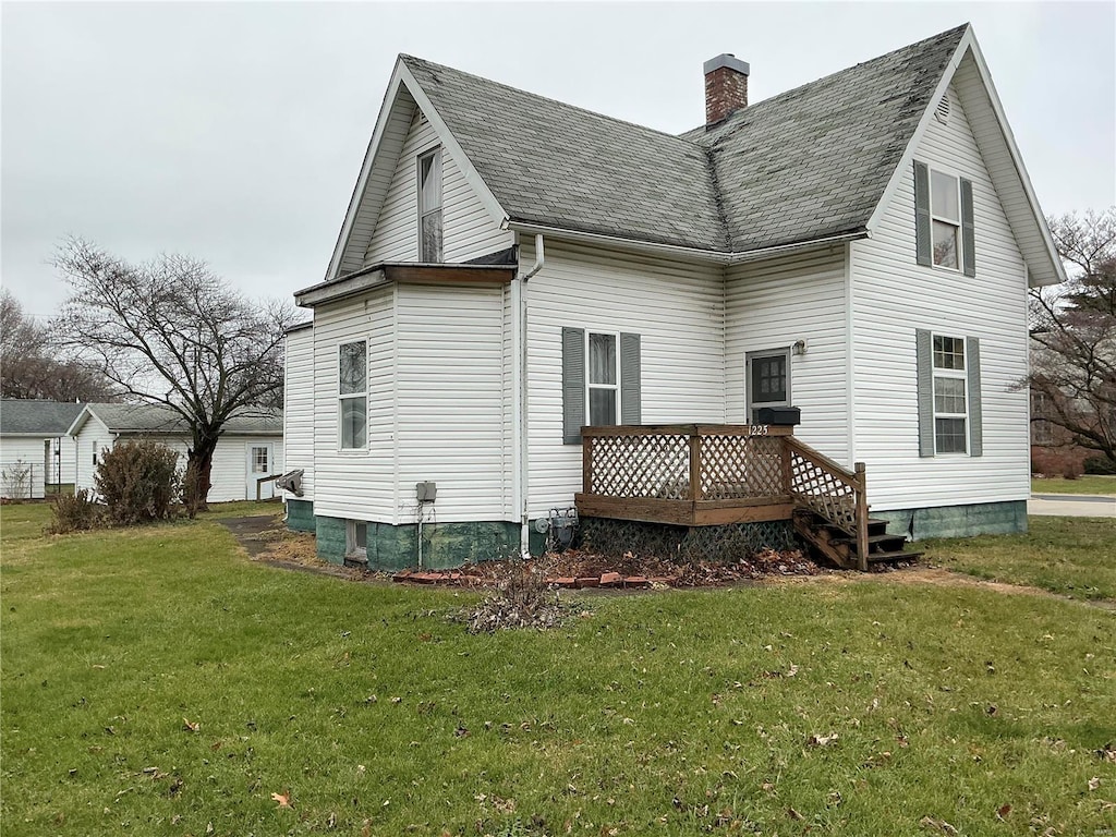 back of house with a lawn and a deck