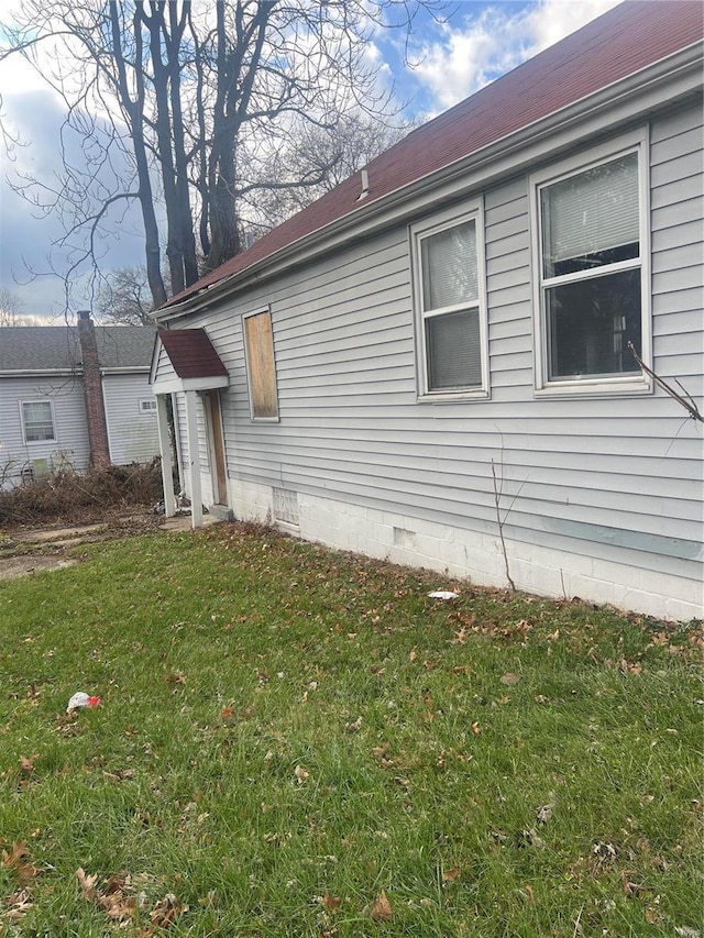 view of home's exterior with a lawn