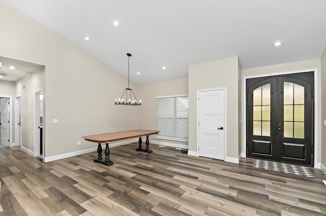 foyer featuring french doors, high vaulted ceiling, and hardwood / wood-style floors