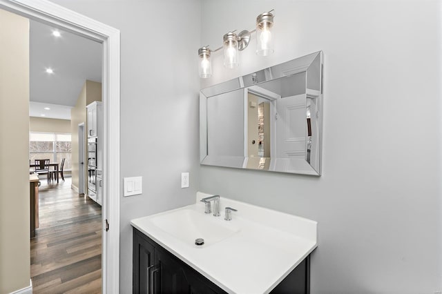 bathroom with hardwood / wood-style flooring and vanity