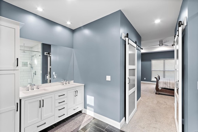 bathroom featuring tiled shower and vanity