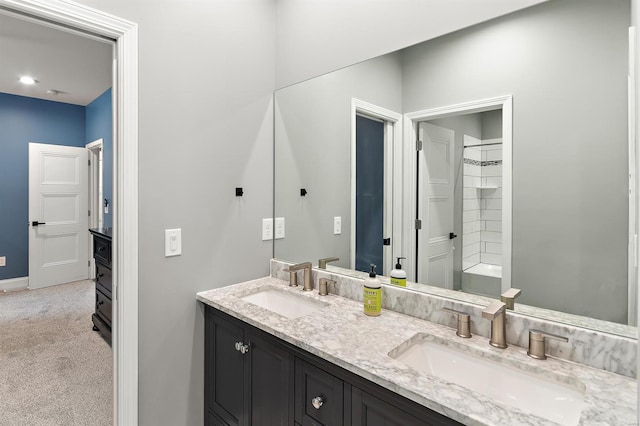 bathroom with a shower and vanity