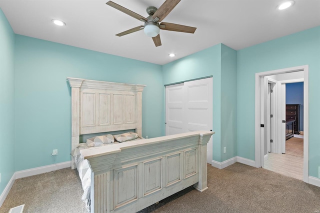 carpeted bedroom featuring a closet and ceiling fan