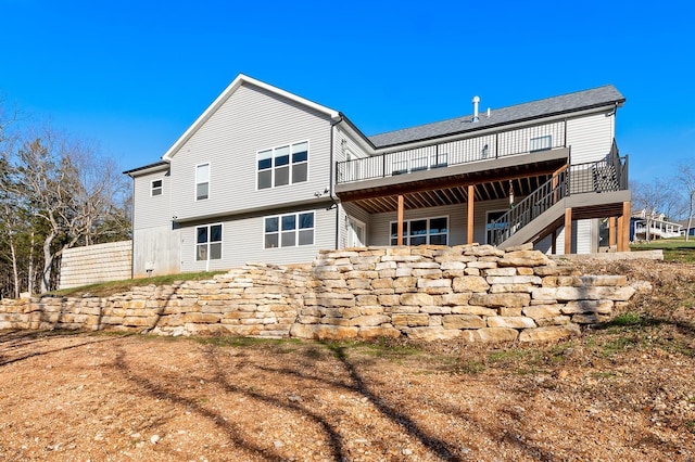 rear view of house with a wooden deck