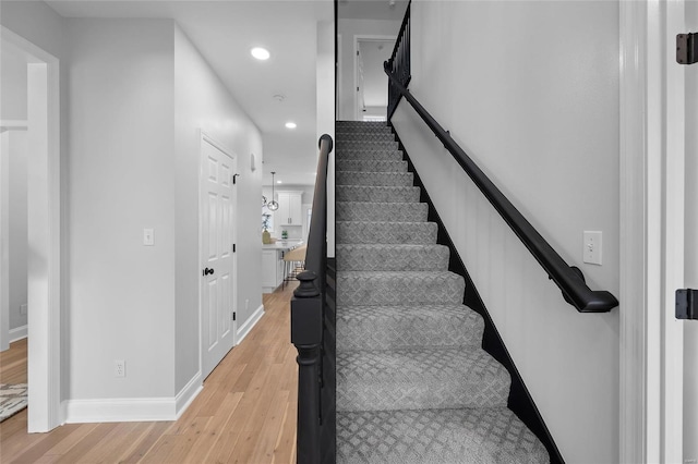 staircase with hardwood / wood-style flooring