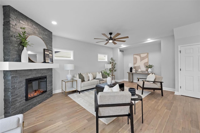 living room featuring ceiling fan and light hardwood / wood-style floors