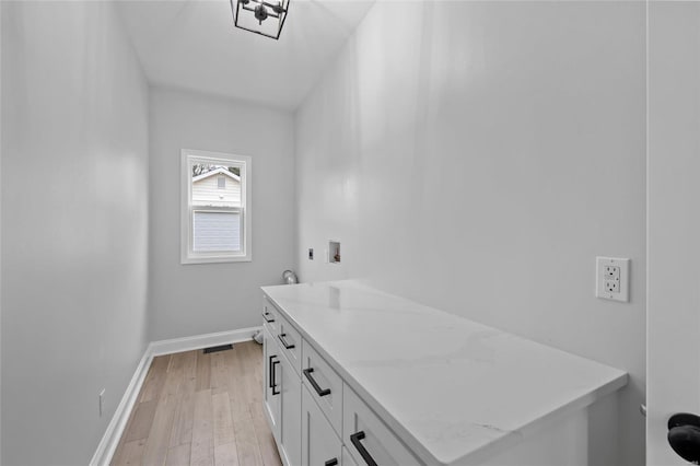 bathroom featuring vanity and wood-type flooring