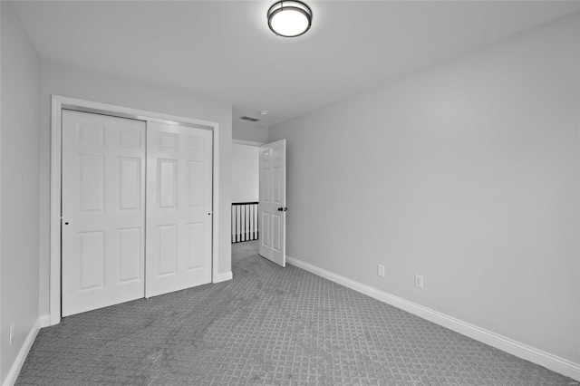 unfurnished bedroom featuring a closet and carpet