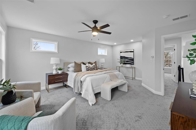 bedroom with multiple windows, ceiling fan, and carpet