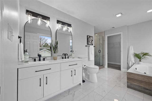 full bathroom featuring toilet, vanity, and shower with separate bathtub