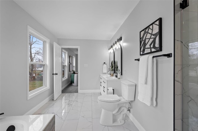 bathroom with vanity, toilet, a shower with shower door, and a wealth of natural light