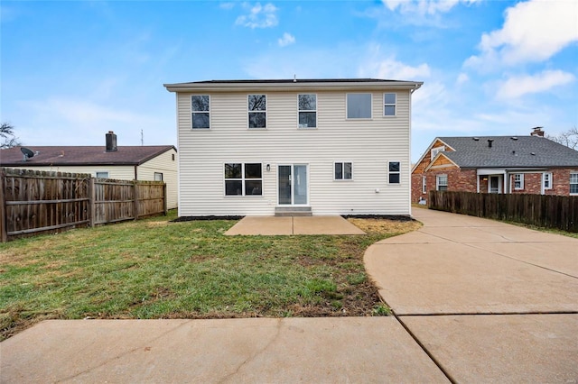 rear view of property featuring a yard and a patio