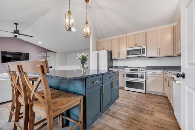 kitchen featuring stainless steel appliances, light hardwood / wood-style floors, decorative light fixtures, lofted ceiling, and a kitchen bar