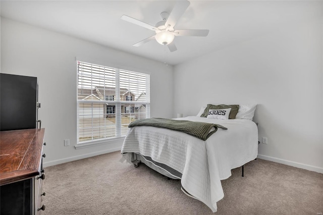 carpeted bedroom with multiple windows and ceiling fan