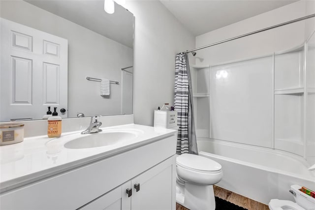 full bathroom featuring vanity, wood-type flooring, shower / bath combo, and toilet