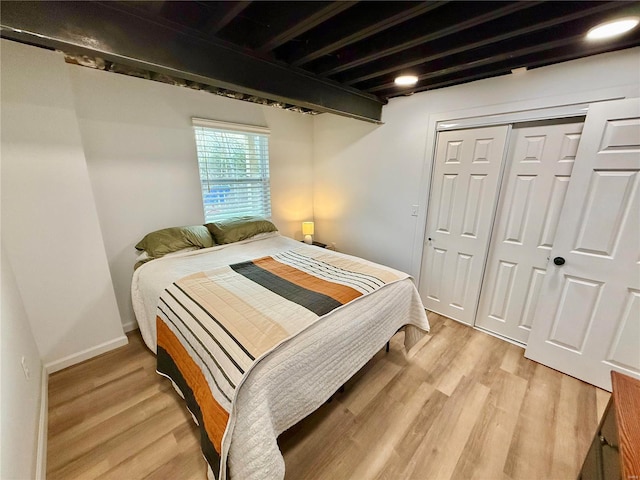 bedroom with a closet and light hardwood / wood-style floors