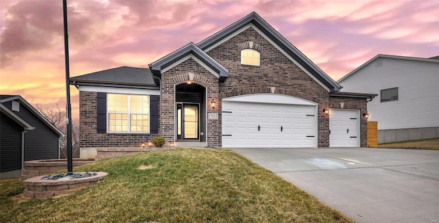 view of front of property with a lawn and a garage