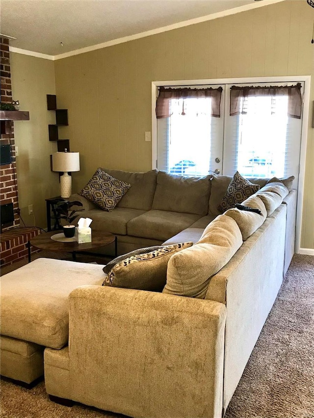 carpeted living room with ornamental molding and a brick fireplace