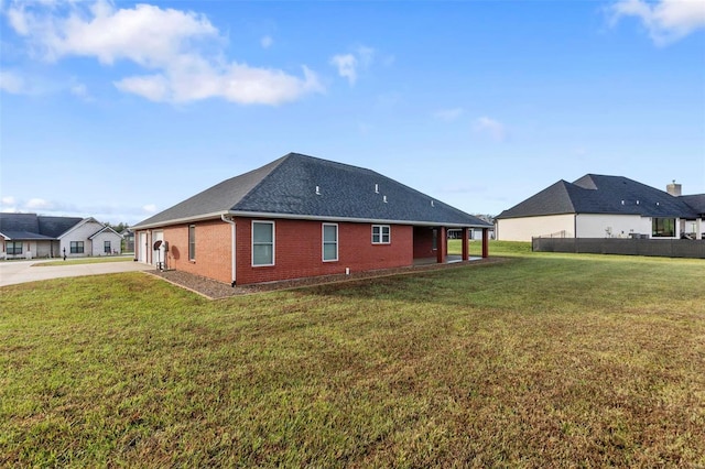 rear view of property featuring a yard