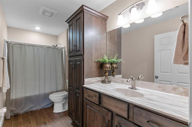 full bathroom featuring vanity, hardwood / wood-style flooring, toilet, and shower / bath combo with shower curtain