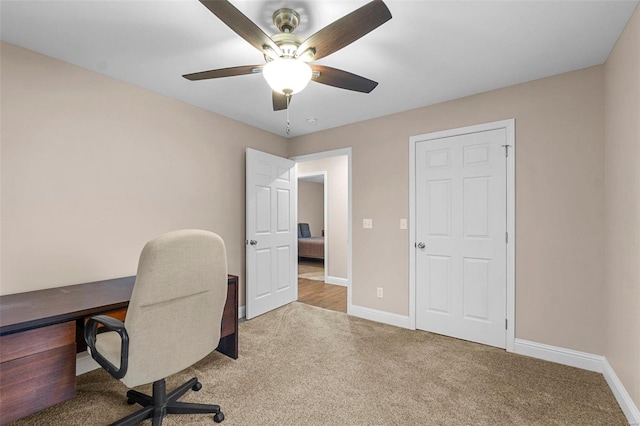 office featuring ceiling fan and light colored carpet