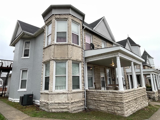 rear view of house featuring central AC unit