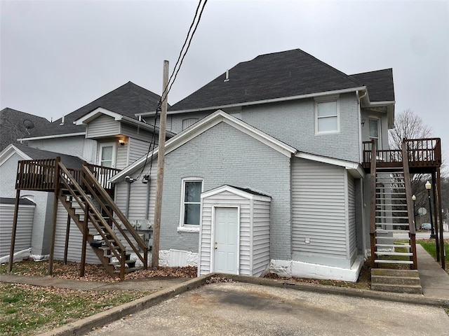 rear view of house with a wooden deck