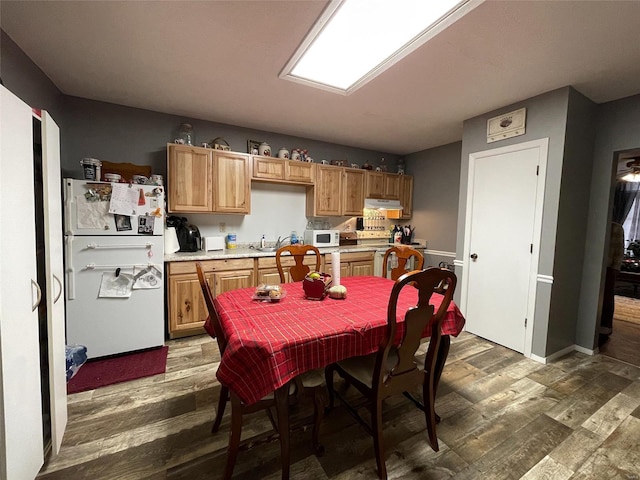 kitchen with sink, dark hardwood / wood-style floors, and white appliances