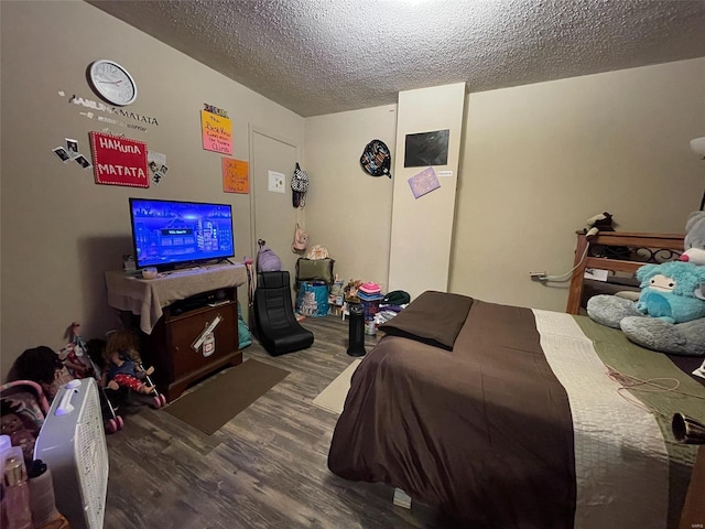 bedroom featuring hardwood / wood-style floors and a textured ceiling