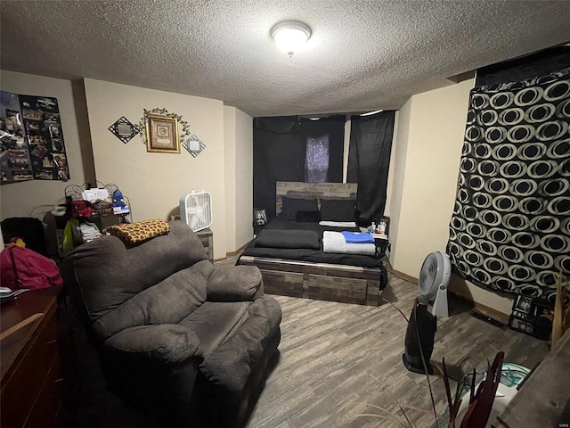 living room with wood-type flooring and a textured ceiling