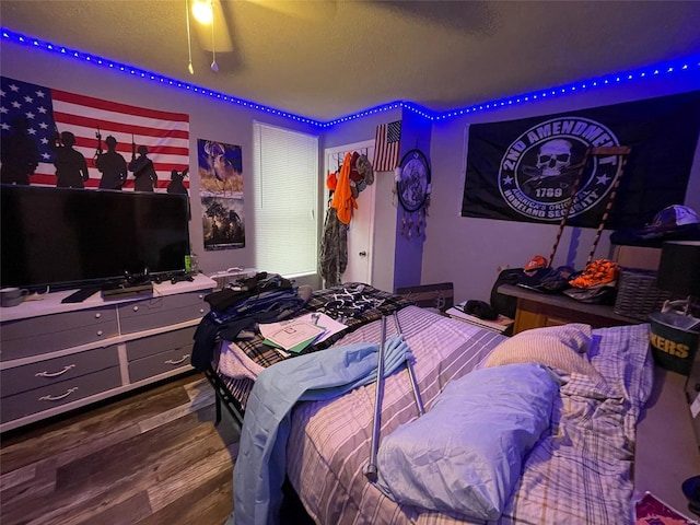 bedroom featuring hardwood / wood-style flooring and a textured ceiling