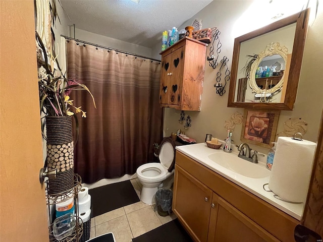 bathroom with vanity, tile patterned flooring, toilet, a textured ceiling, and curtained shower