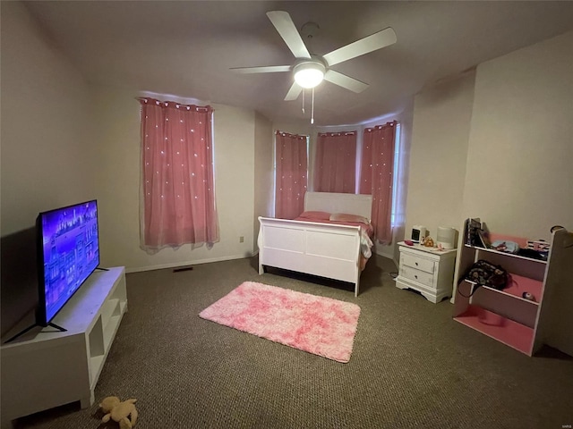 bedroom featuring ceiling fan and dark carpet