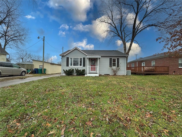 single story home featuring a front yard and a wooden deck