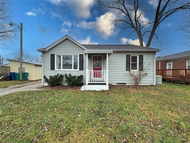 ranch-style house with central AC unit and a front yard