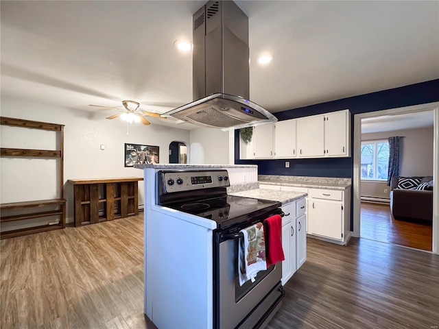 kitchen featuring white cabinetry, ceiling fan, dark wood-type flooring, island exhaust hood, and stainless steel range with electric cooktop