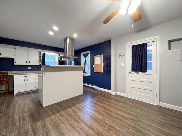 kitchen featuring dark hardwood / wood-style floors, a kitchen island, white cabinetry, and island exhaust hood