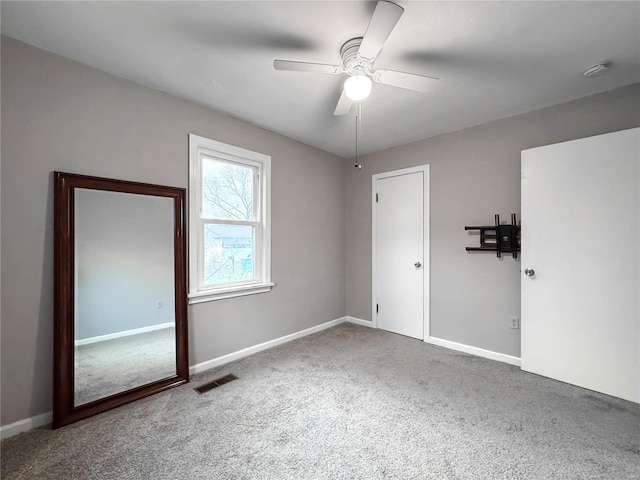 unfurnished bedroom featuring carpet and ceiling fan