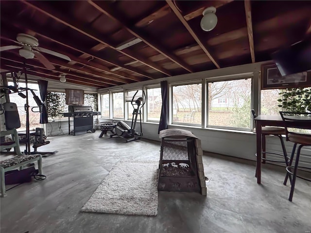 sunroom / solarium with a wealth of natural light, ceiling fan, and lofted ceiling