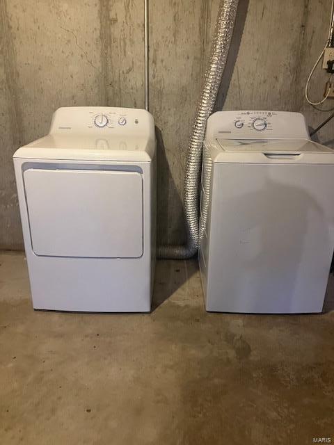 clothes washing area with washer and clothes dryer