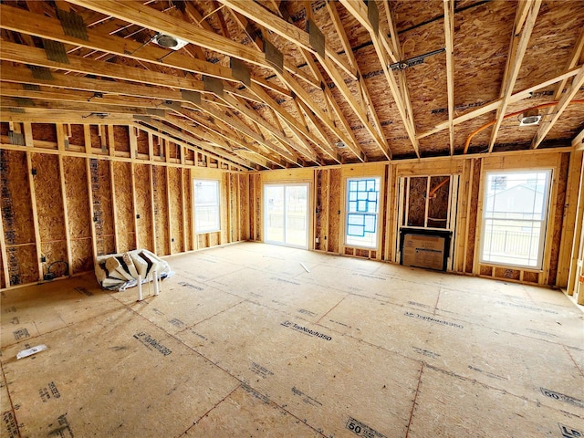 miscellaneous room with a healthy amount of sunlight and lofted ceiling