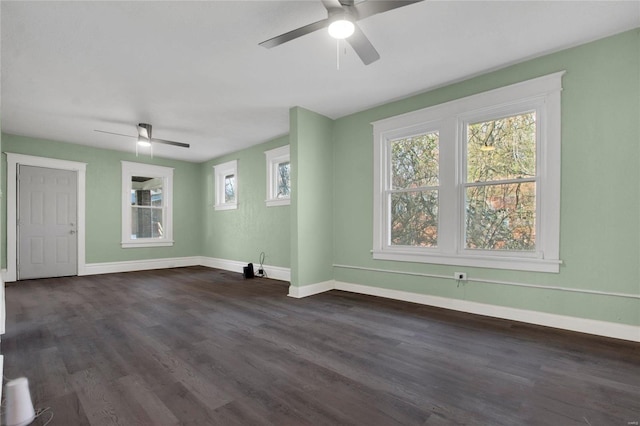 unfurnished living room with ceiling fan and dark wood-type flooring