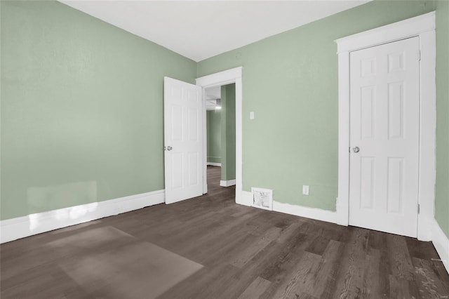 unfurnished bedroom featuring dark wood-type flooring